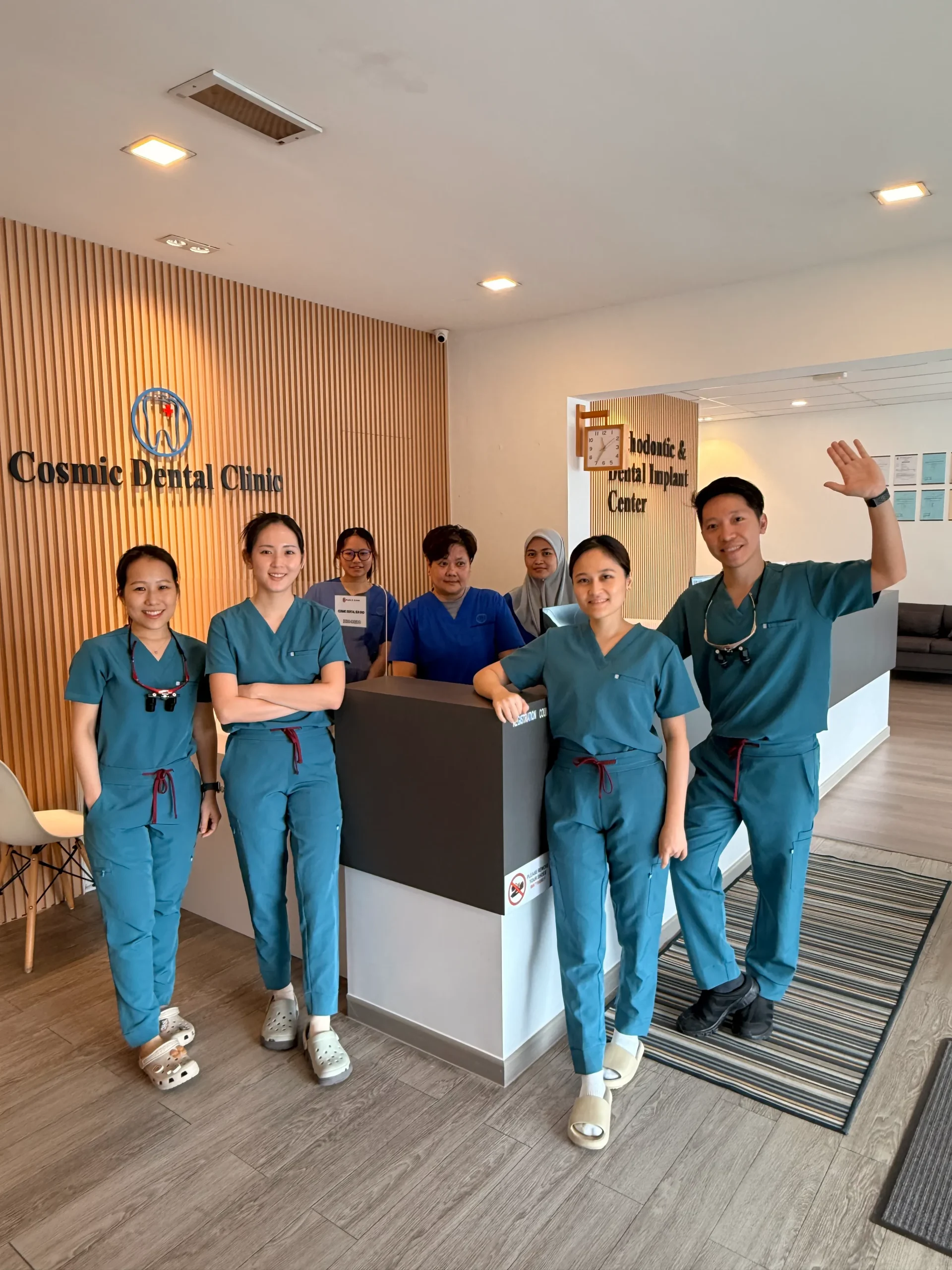 Cosmic Dental Clinic team portrait near the entrance
